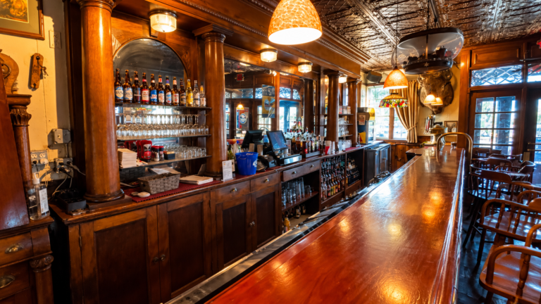 The long wooden bar inside Trainwreck Saloon